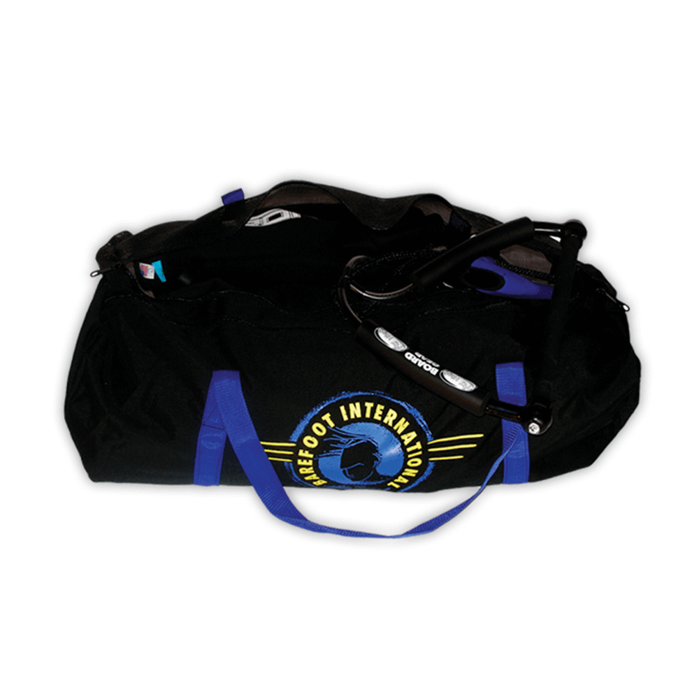 Black duffel-style Wet/Dry Bag with blue handles and Barefoot International logo, partially unzipped showing stored gear.